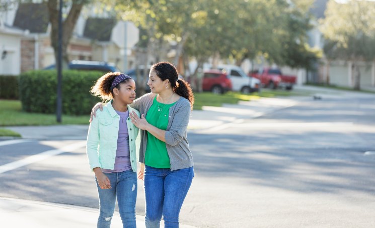 mom and daughter walking 745w